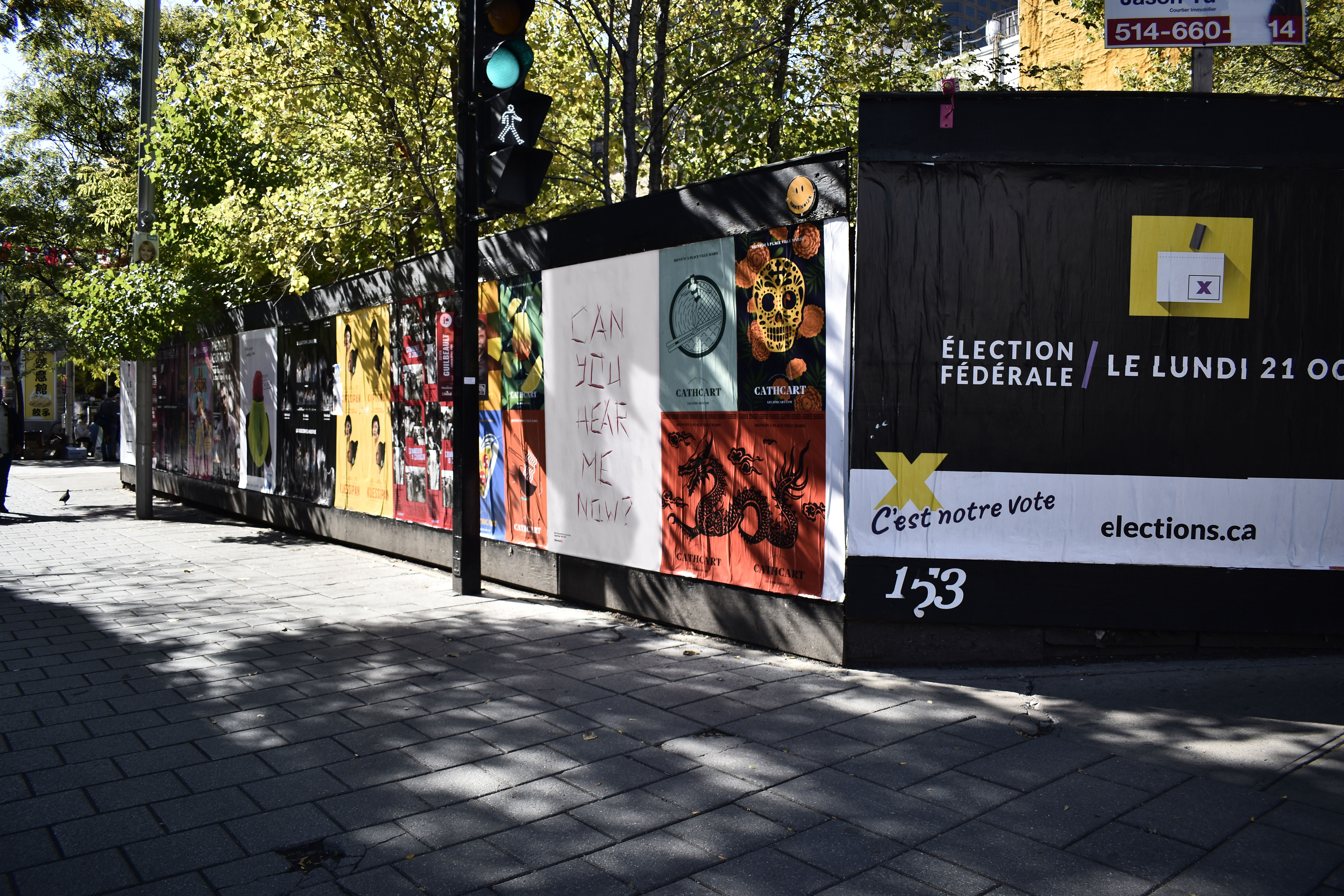 Poster seen in context with a shadow over it